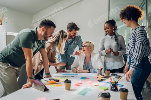 Preview: Group of diverse business people working together and having a meeting