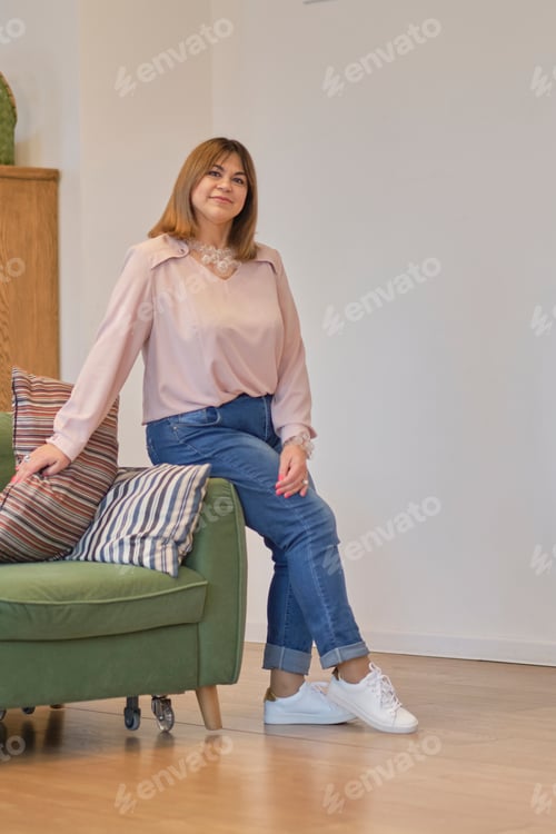 Preview: self-sufficient confident middle-aged woman. sitting on a chair in a confident posture.