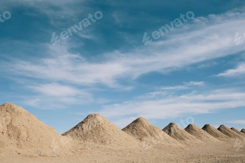 Preview: Mining tailings creating row of dirt piles in a desert, mine extraction.