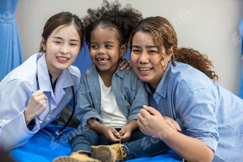 Preview: Child having fun on bed in hospital. Little girl and doctor happy in hospital. Hospital Ward: little