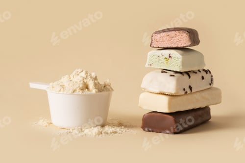 Preview: Protein bars and scoop of powder on beige background.