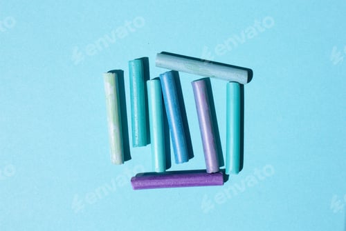 Preview: Blue and purple crayons pastels on a light blue background