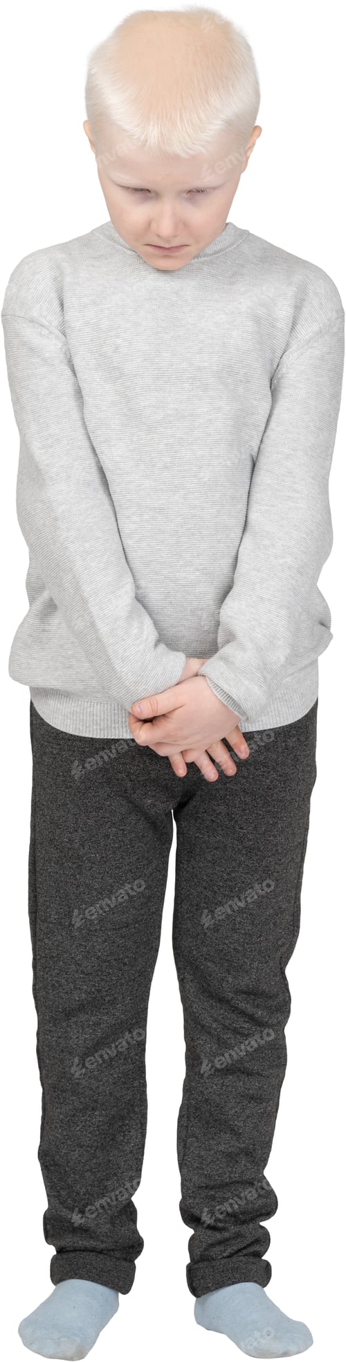 Preview: a young boy is standing with his hands in his pockets