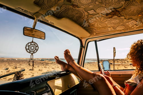 Preview: Interior of classic van camper with beautiful legs of woman stretched and relaxed. Travel people