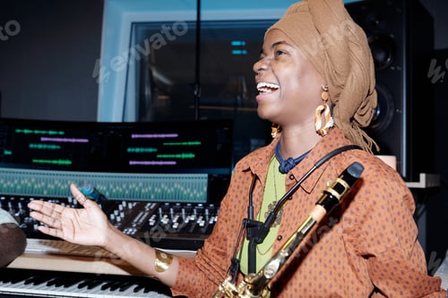 Preview: Laughing Musician Holding Saxophone During Recording Session