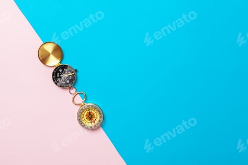 Preview: Compass on pink background, top view. creative photo