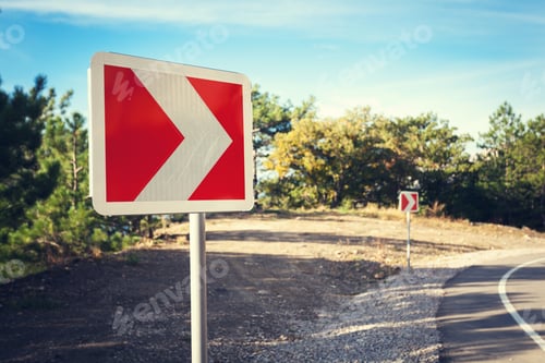 Preview: Asphalt road in autumn forest at sunrise and road sign