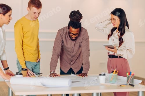 Preview: Multiracial team of engineers or architects having a meeting in an office