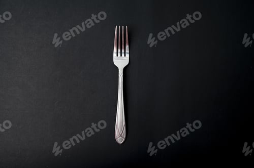 Preview: Top view of the fork on a black background