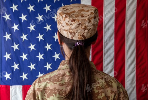Preview: Female US Army Soldier in front of an American flag. Woman in military uniform rear view
