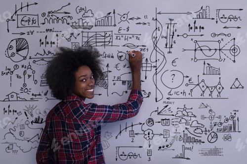Preview: African American woman writing on a chalkboard in a modern offic