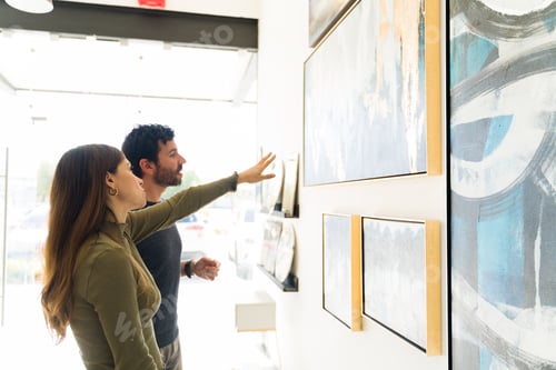 Preview: Good-Looking Young Woman And Adult Man Are Deciding Which Art Painting To Buy For Their Home From