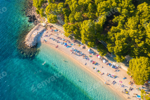 Preview: Aerial view of sandy beach with colorful umbrellas, blue sea sea