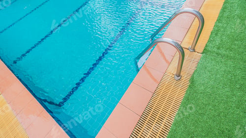 Preview: Swimming poolside with blue water and stairs and corner, free space for text presentation
