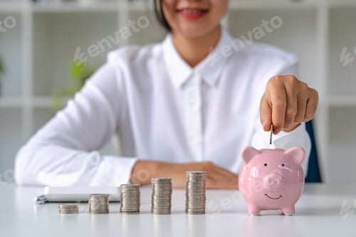 Preview: woman's hands saving money in piggy bank, saving money for the future for retirement savings from wo