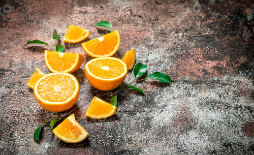 Preview: Pieces of fresh oranges with leaves.