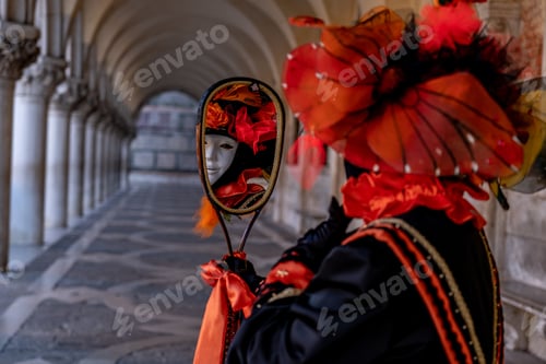 Preview: Person wearing a black and red costume looking in a mirror