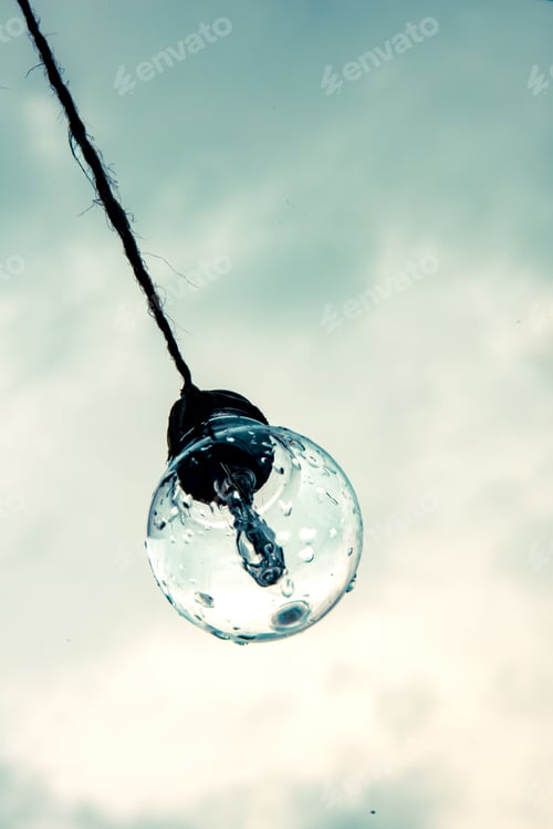 Preview: Wet Light Bulb Hanging Against a Cloudy Sky