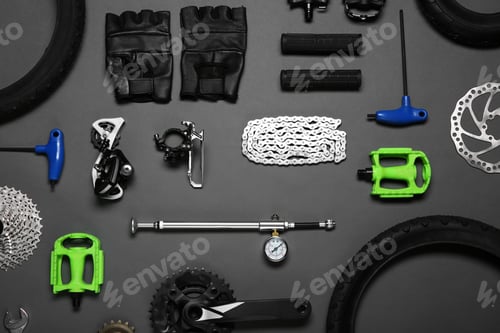 Preview: Set of different bicycle tools and parts on grey background, flat lay