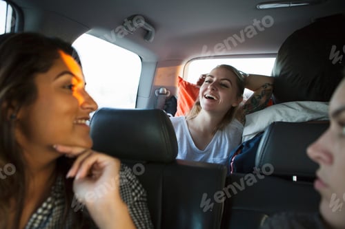 Preview: Young women laughing in car