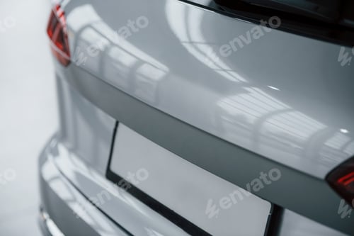 Preview: Automobile trunk. Particle view of modern luxury white car parked indoors at daytime