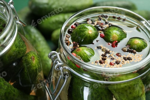 Preview: Making pickles. Fresh cucumbers and spices in jar, closeup