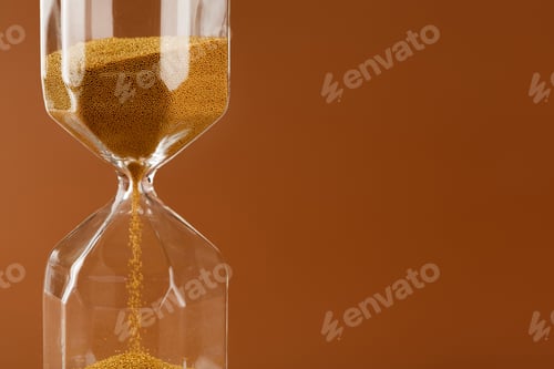 Preview: Close up of sandglass on paper background