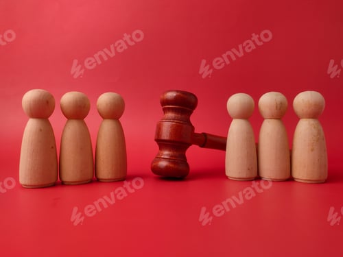 Preview: Stock photo illustrating legal concepts using a judge's gavel and wooden figures