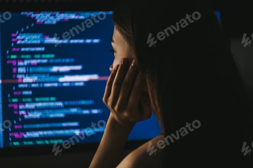 Preview: Young female programmer writes program code on a computer. home office