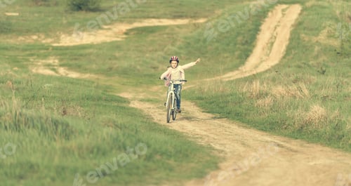 Preview: smiling little girl riding a bike