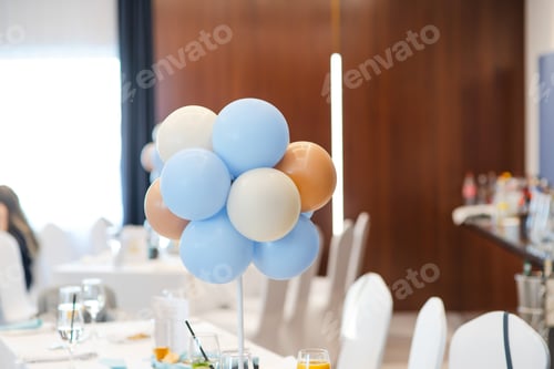Preview: Party treats and items on table in room decorated with balloons