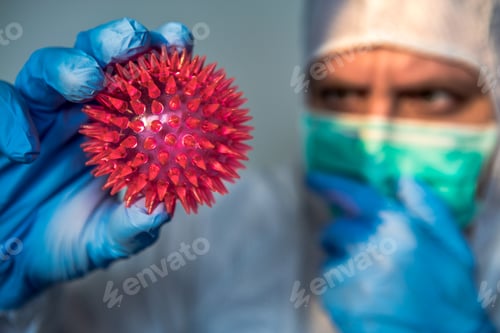 Preview: Health Worker Holds Virus Model in Protective Gear