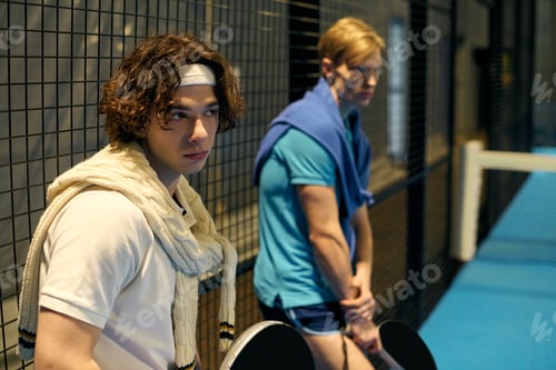 Preview: Excitement builds as young sportsmen prepare for a thrilling padel match indoors