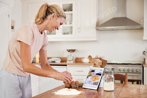 Preview: Woman Baking at Home following Digital Tablet Recipe