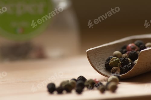 Preview: Colorful peppercorns spilling from a wooden spoon