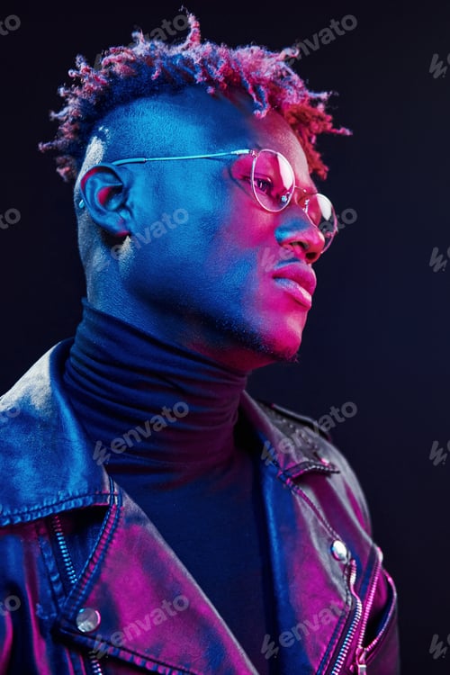 Preview: In glasses. Futuristic neon lighting. Young african american man in the studio