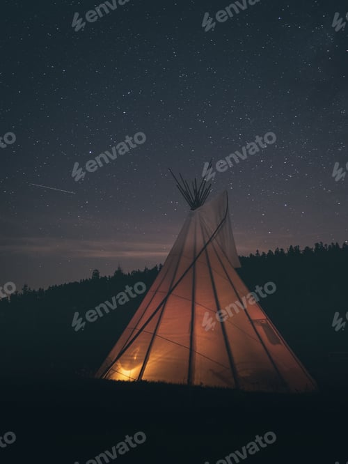 Preview: Vertical shot of a tent in the nature against a dark starry sky