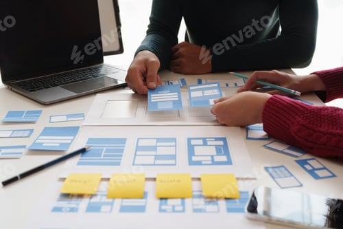 Preview: Group of ux developer and ui designer brainstorming about app interface design at modern office