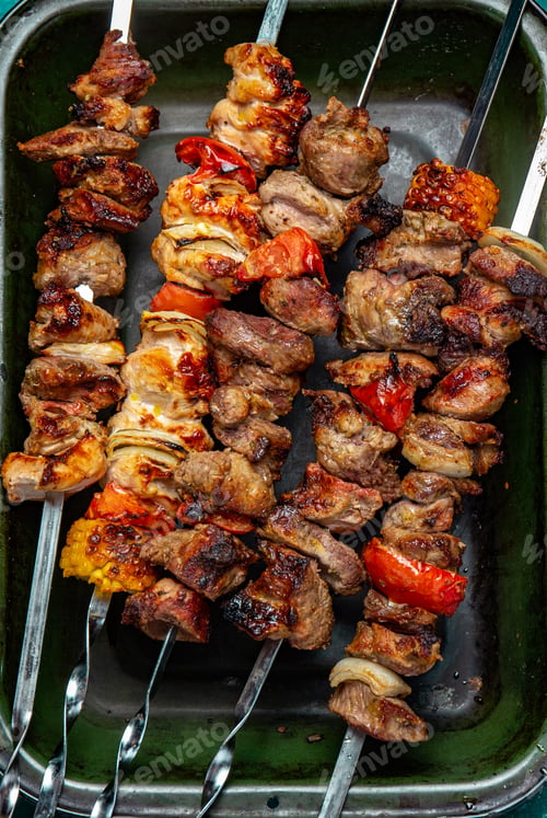 Preview: Bbq grilled meat pork, chicken and vegetable skewers on tray. Top view, flat lay
