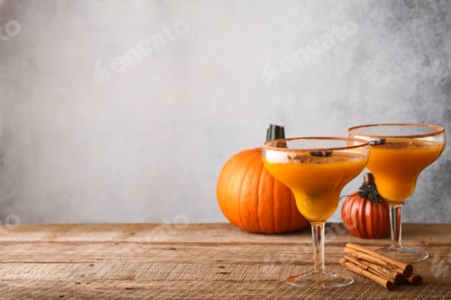 Preview: Pumpkin cocktail with cinnamon, orange juice and cocoa in glass mugs. Festive cocktail Halloween mar