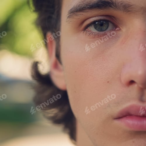 Preview: Half face of an young man. Close-up male eye - soft focus. Part of face of the young guy.