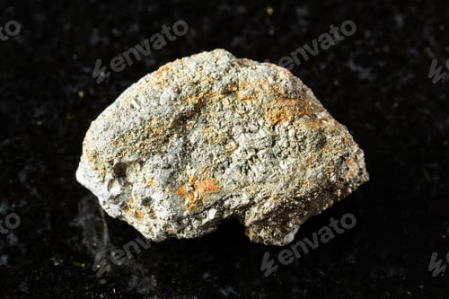 Preview: sample of uncut pyrite rock on black granite