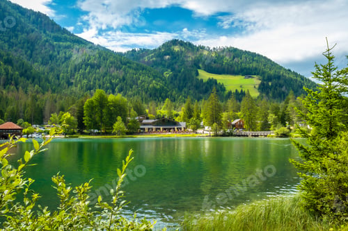 Preview: Breathtaking lake dobbiaco reflecting surrounding dolomites landscape in summer