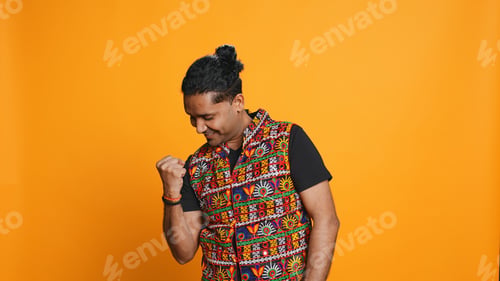 Preview: Portrait of joyful man celebrating, studio background