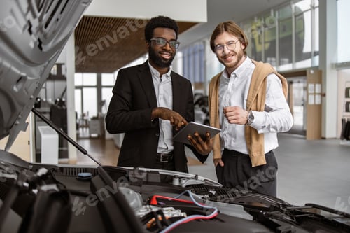 Preview: Professional consultant showing choosing buying car to buyer,looking camera.