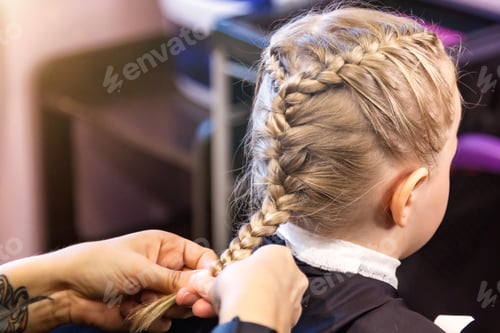 Preview: Hair salon. Close-up of hands barber makes fashionable braids hairstyle