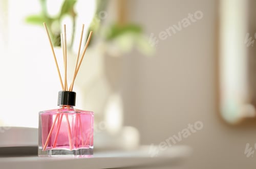 Preview: Aromatic reed air freshener on table against blurred background