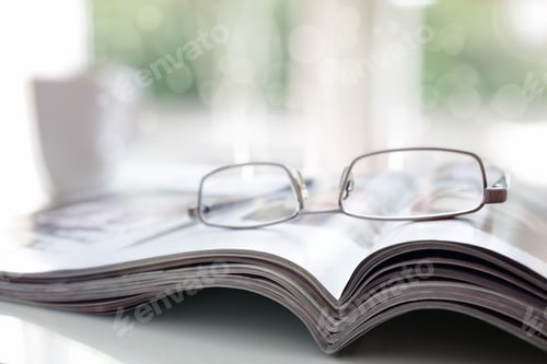 Preview: Magazine and Glasses on a Bright Background