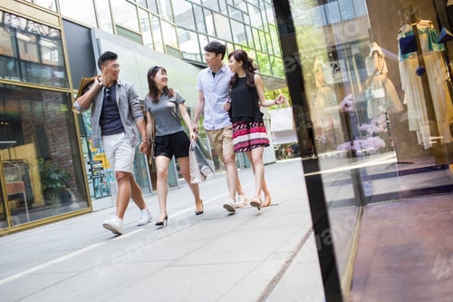 Preview: Happy young friends with shopping bags