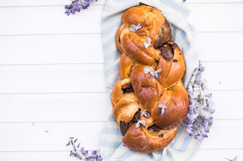 Preview: Tsoureki traditional baked Greek Easter sweet bread. Easter time, springtime. Holiday food concept.